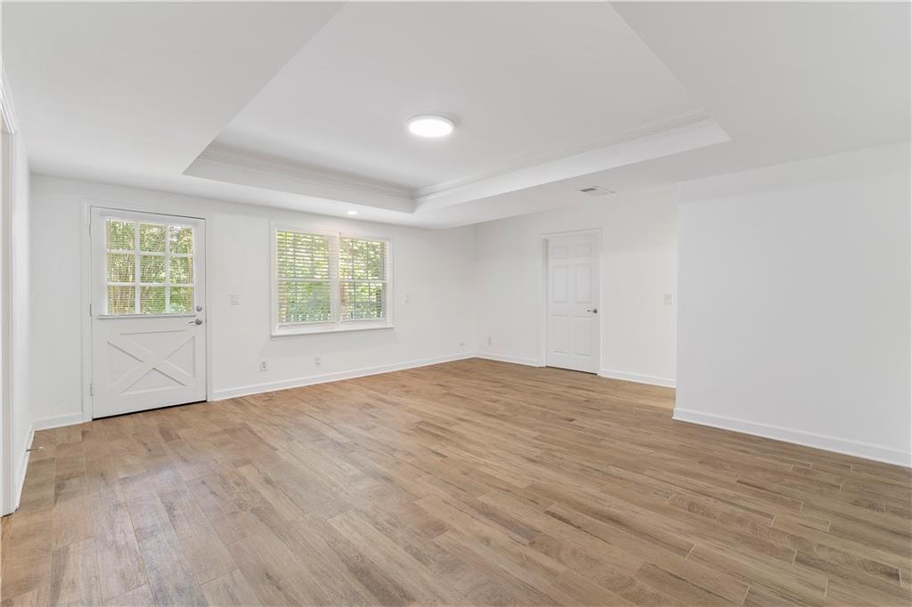 8965 Laurel Way Alpharetta, GA 30022 - Photo 51 of 79 an empty room with wooden floor and windows