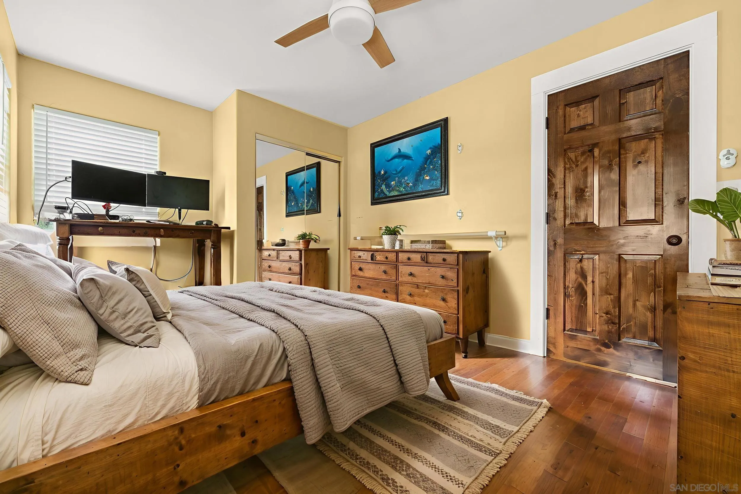 4685 Long Branch Avenue San Diego, CA 92107 - Photo 11 of 27 a bedroom with a bed and wooden floor