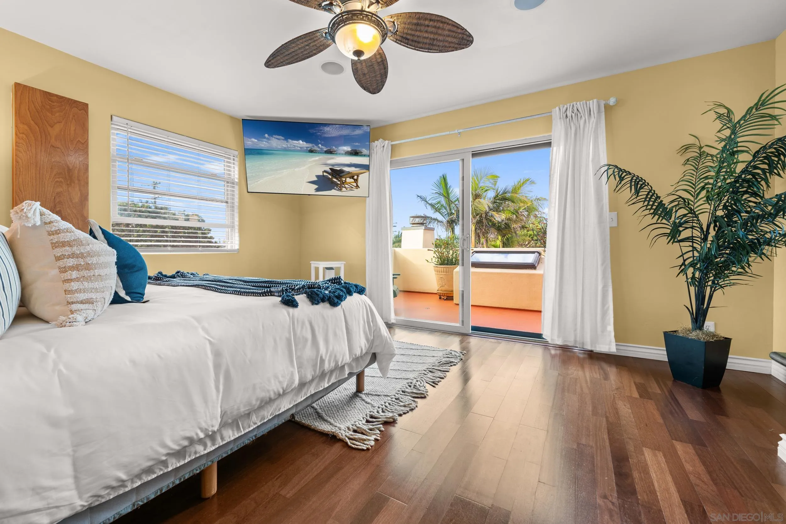 4685 Long Branch Avenue San Diego, CA 92107 - Photo 14 of 27 a bedroom with a large bed and a chandelier