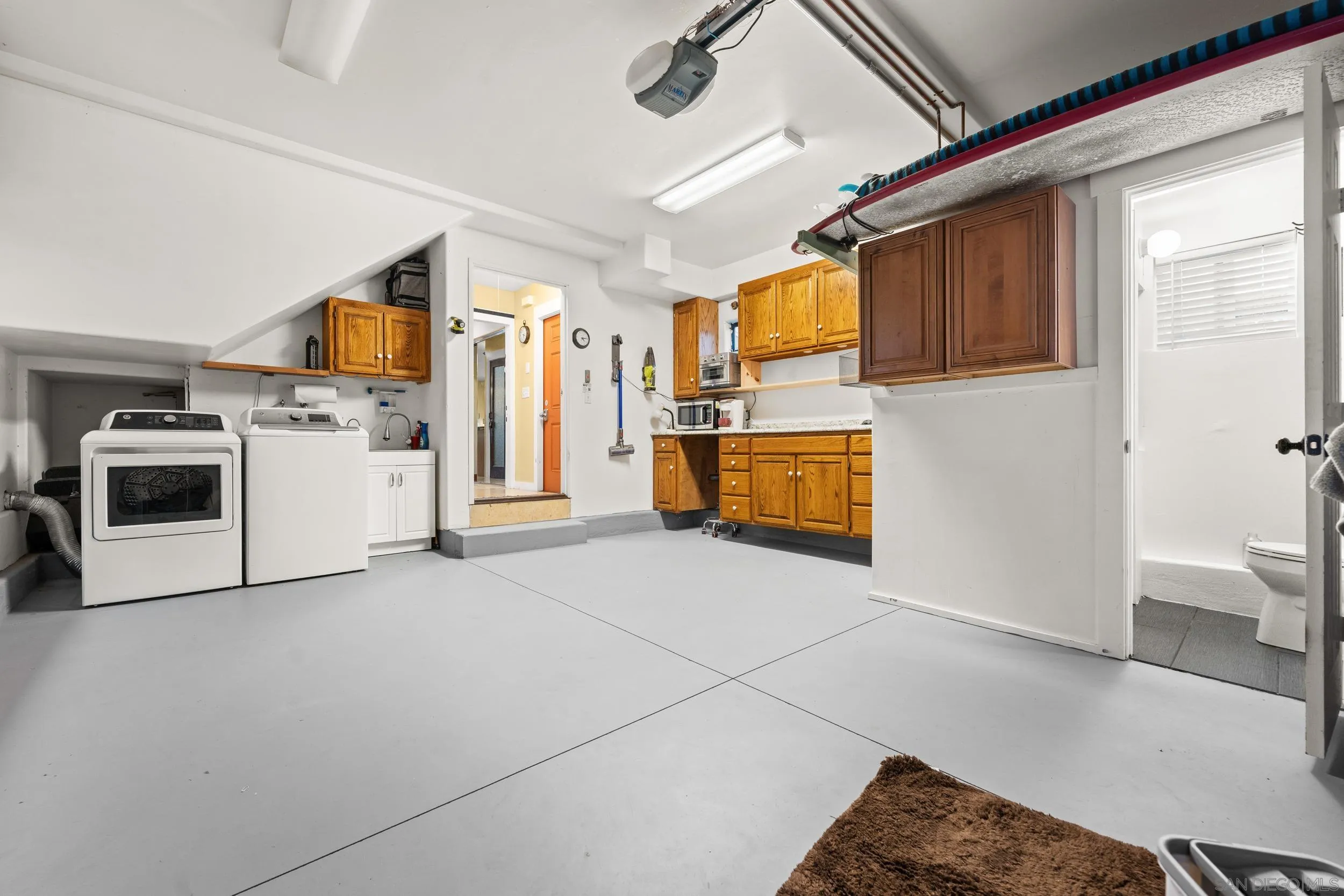 4685 Long Branch Avenue San Diego, CA 92107 - Photo 22 of 27 a kitchen with a refrigerator and a stove top oven