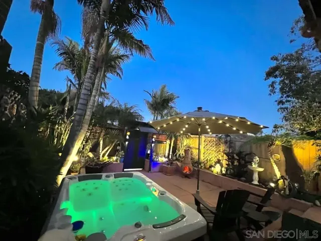 a view of a backyard with sitting area