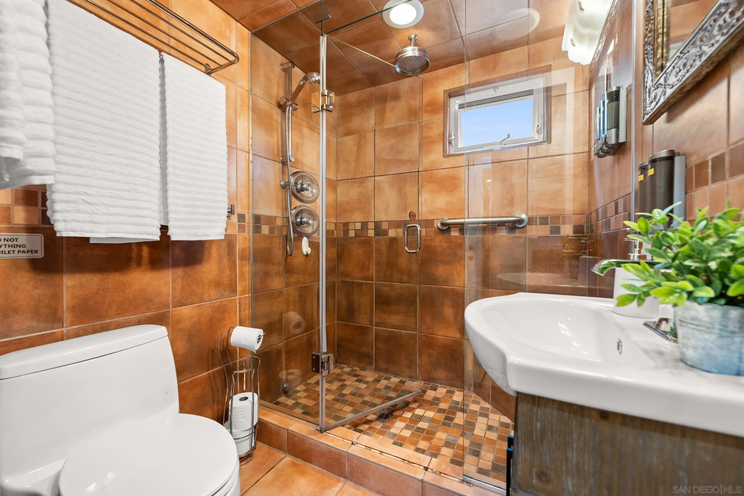 4685 Long Branch Avenue San Diego, CA 92107 - Photo 9 of 27 a bathroom with a sink toilet and shower