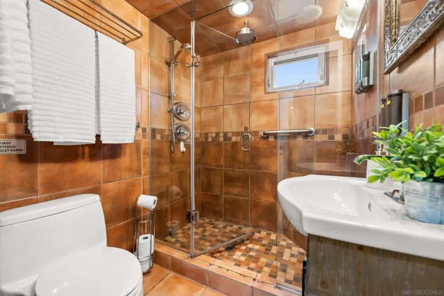 a spacious bedroom with a bed and a chandelier