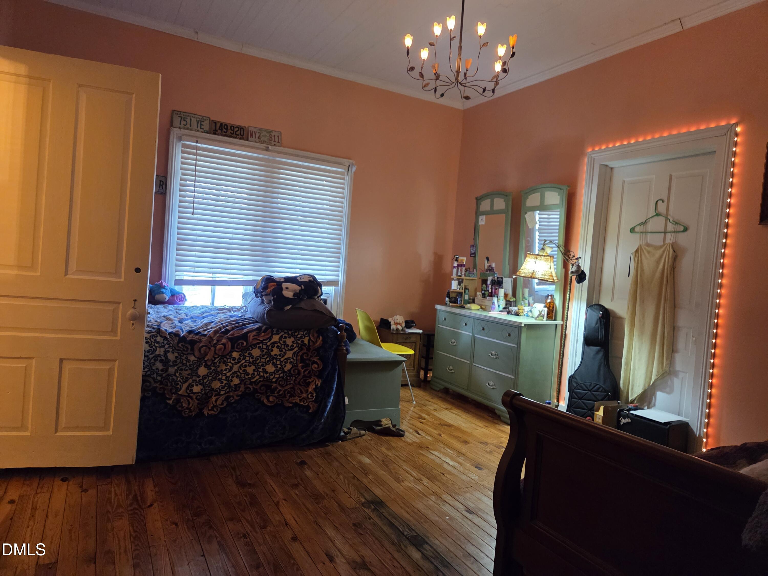 812 West Anderson Street Selma, NC 27576 - Photo 13 of 20 a bed room with furniture and a chandelier