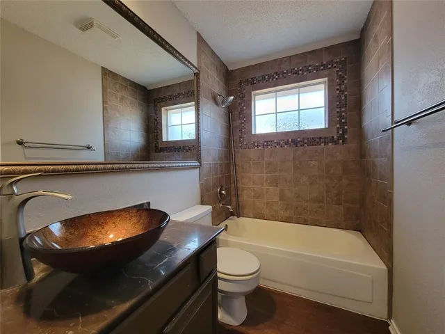a bathroom with a sink a toilet and a bathtub