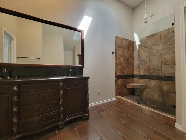 a bathroom with a shower and a sink