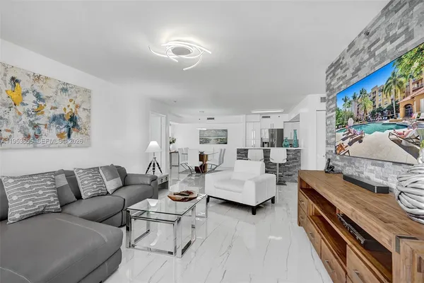 a living room with furniture and a flat screen tv