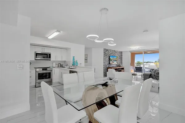 a kitchen with stainless steel appliances a refrigerator sink and microwave