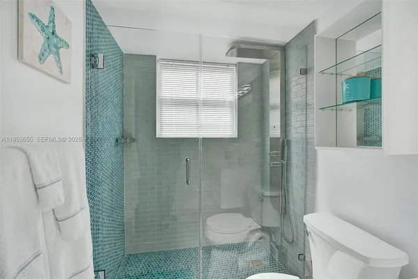 a bedroom with a bed next to a window