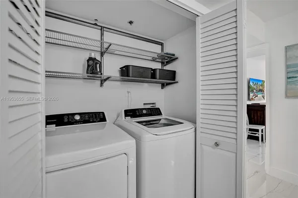 a kitchen with stainless steel appliances white cabinets and white appliances