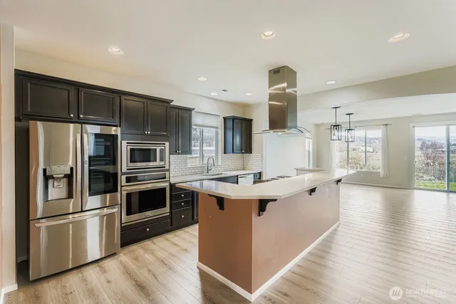 a kitchen with stainless steel appliances a sink stove and refrigerator
