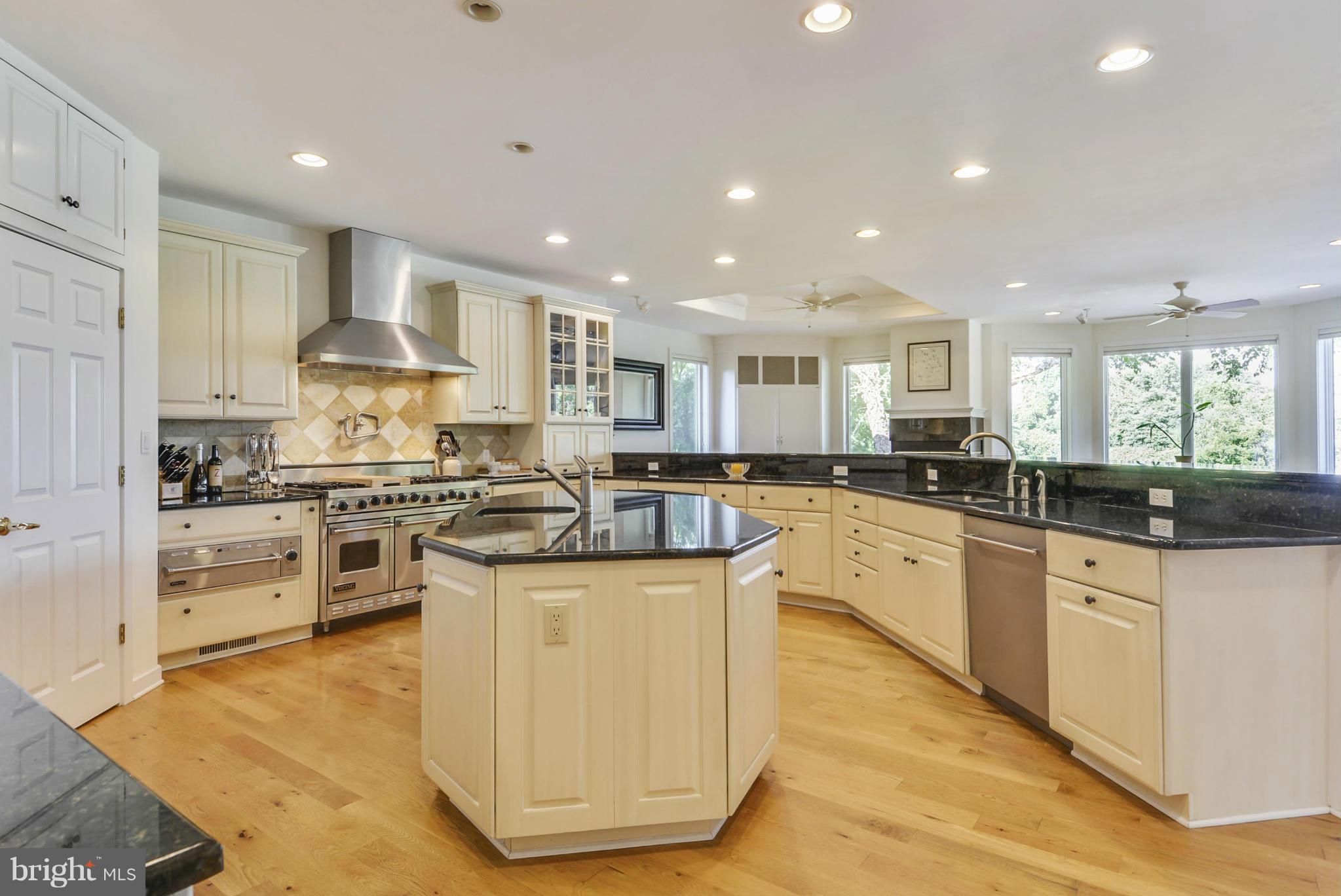1690 Cox Neck Road Chester, MD 21619 - Photo 10 of 28 a kitchen with stainless steel appliances granite countertop a stove top oven a sink and a refrigerator