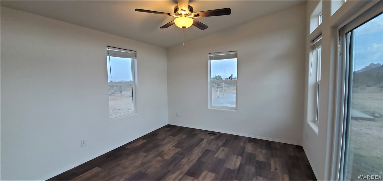 1434 Dilcon Road Golden Valley, AZ 86413 - Photo 14 of 49 a view of empty room with wooden floor and fan