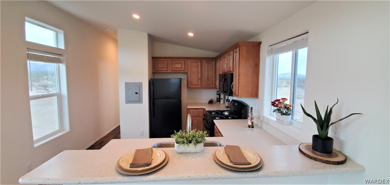 1434 Dilcon Road Golden Valley, AZ 86413 - Photo 19 of 49 a kitchen with stainless steel appliances kitchen island granite countertop a refrigerator and microwave