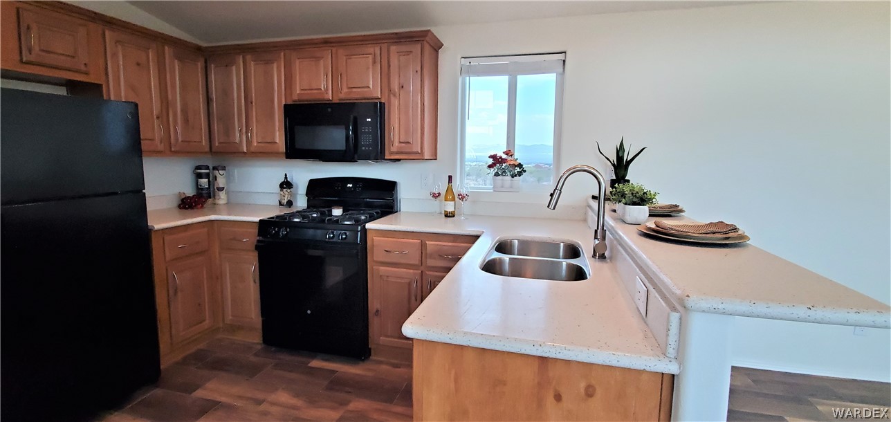 1434 Dilcon Road Golden Valley, AZ 86413 - Photo 22 of 49 a kitchen with a sink a stove and refrigerator