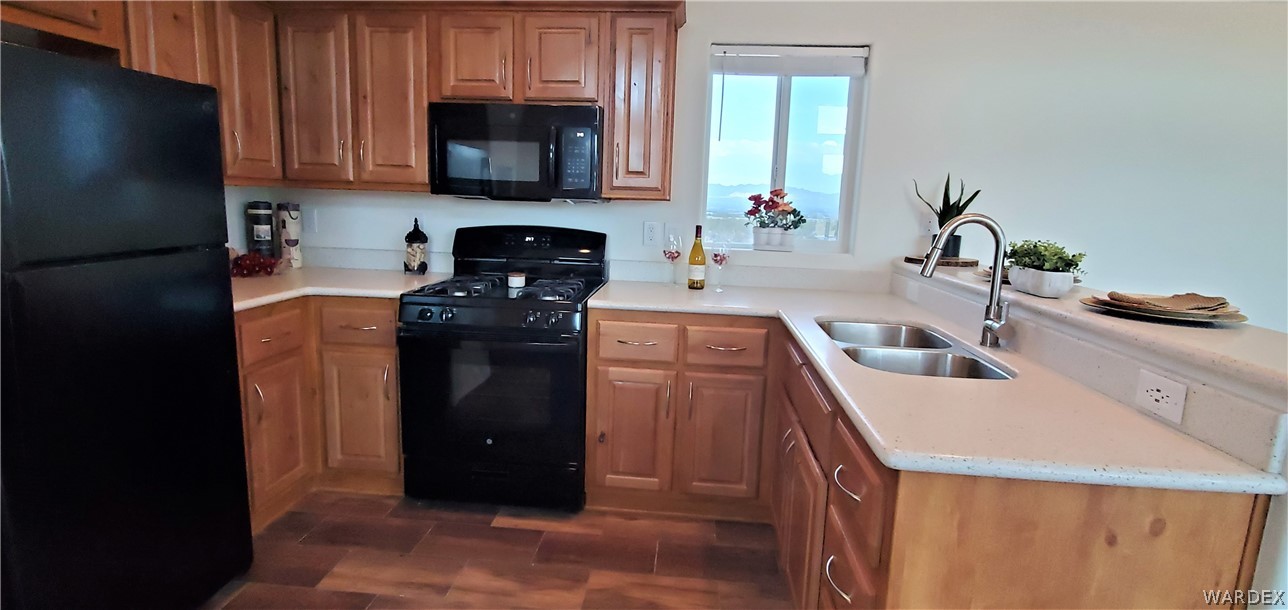 1434 Dilcon Road Golden Valley, AZ 86413 - Photo 23 of 49 a kitchen with a sink and a refrigerator