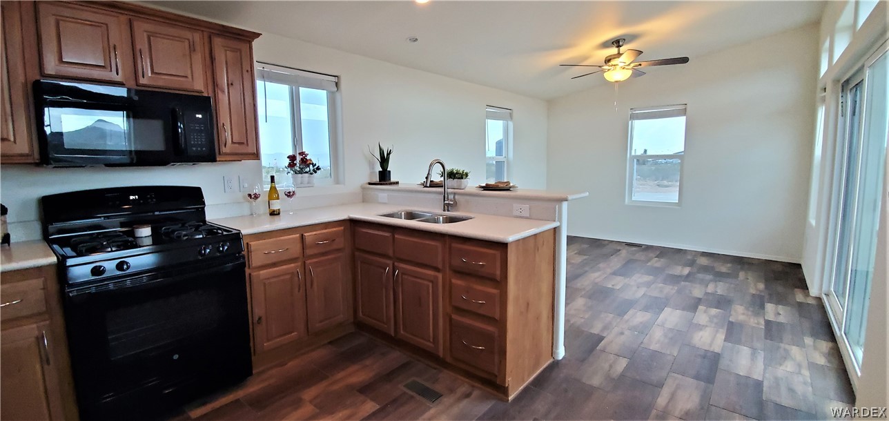 1434 Dilcon Road Golden Valley, AZ 86413 - Photo 28 of 49 a kitchen with a sink stove and microwave