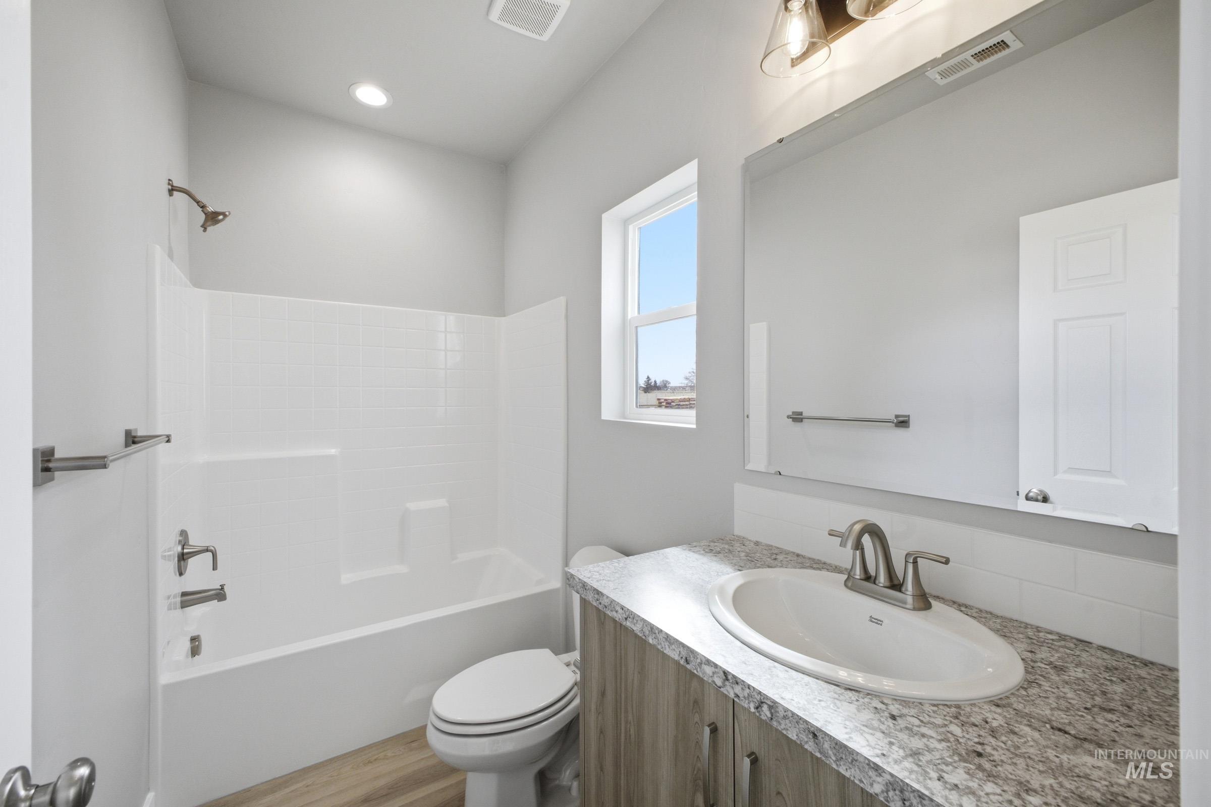 13672 Redway Court Caldwell, ID 83607 - Photo 16 of 34 Bathroom with vanity, tub / shower combination, and light wood-style flooring
