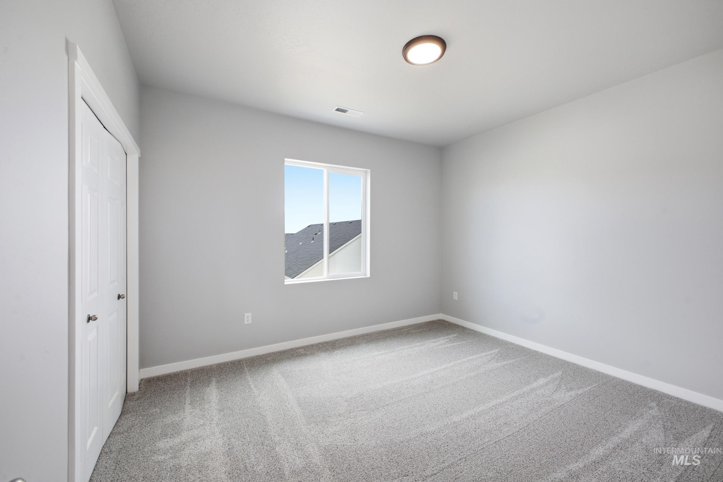 13672 Redway Court Caldwell, ID 83607 - Photo 20 of 34 Unfurnished bedroom with light carpet and a closet