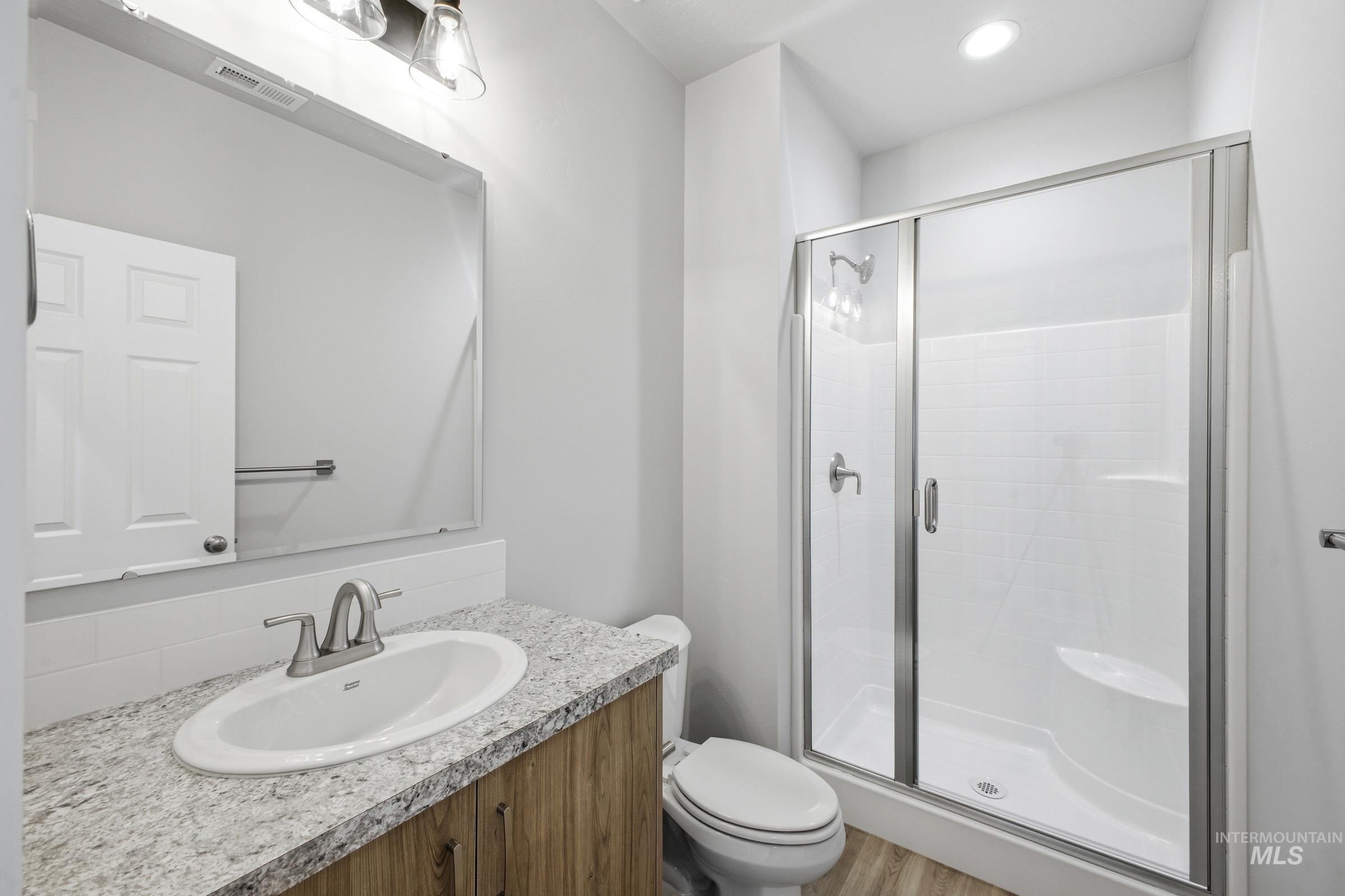 13672 Redway Court Caldwell, ID 83607 - Photo 21 of 34 Full bath with vanity, a stall shower, light wood-style floors, and recessed lighting