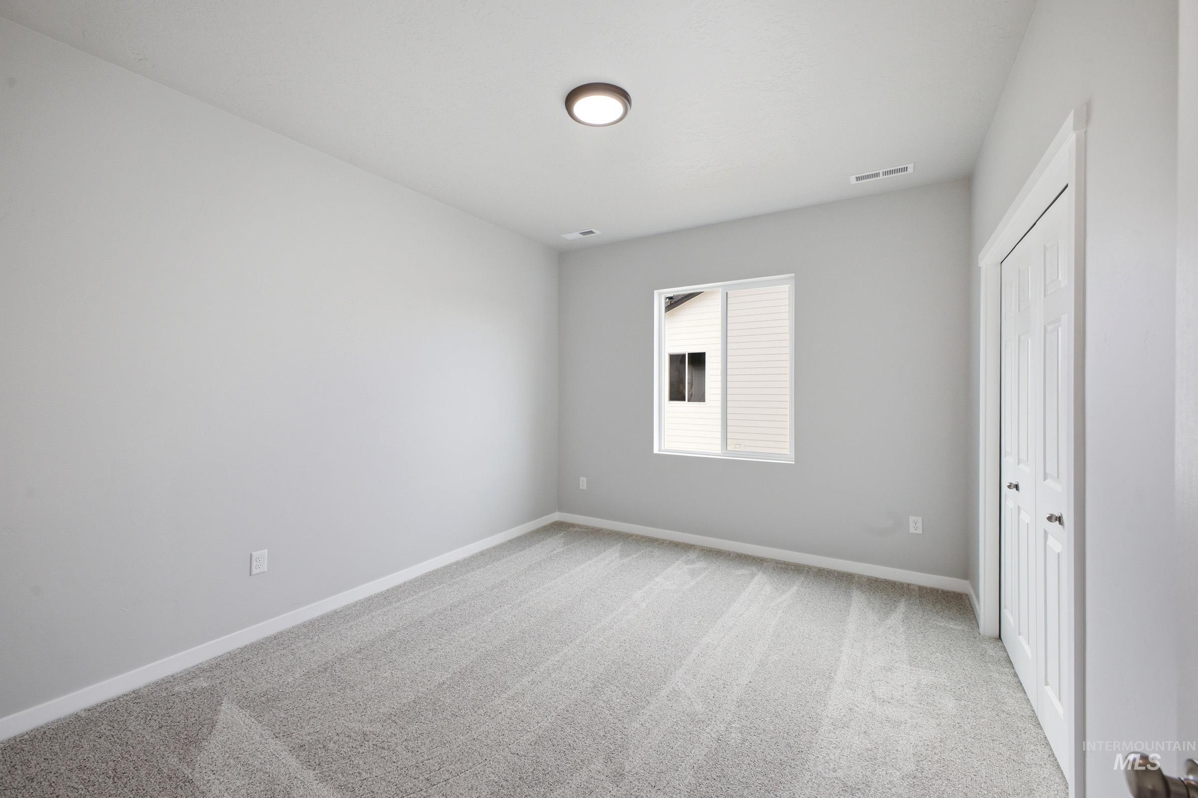 13672 Redway Court Caldwell, ID 83607 - Photo 24 of 34 Unfurnished bedroom featuring light carpet and a closet