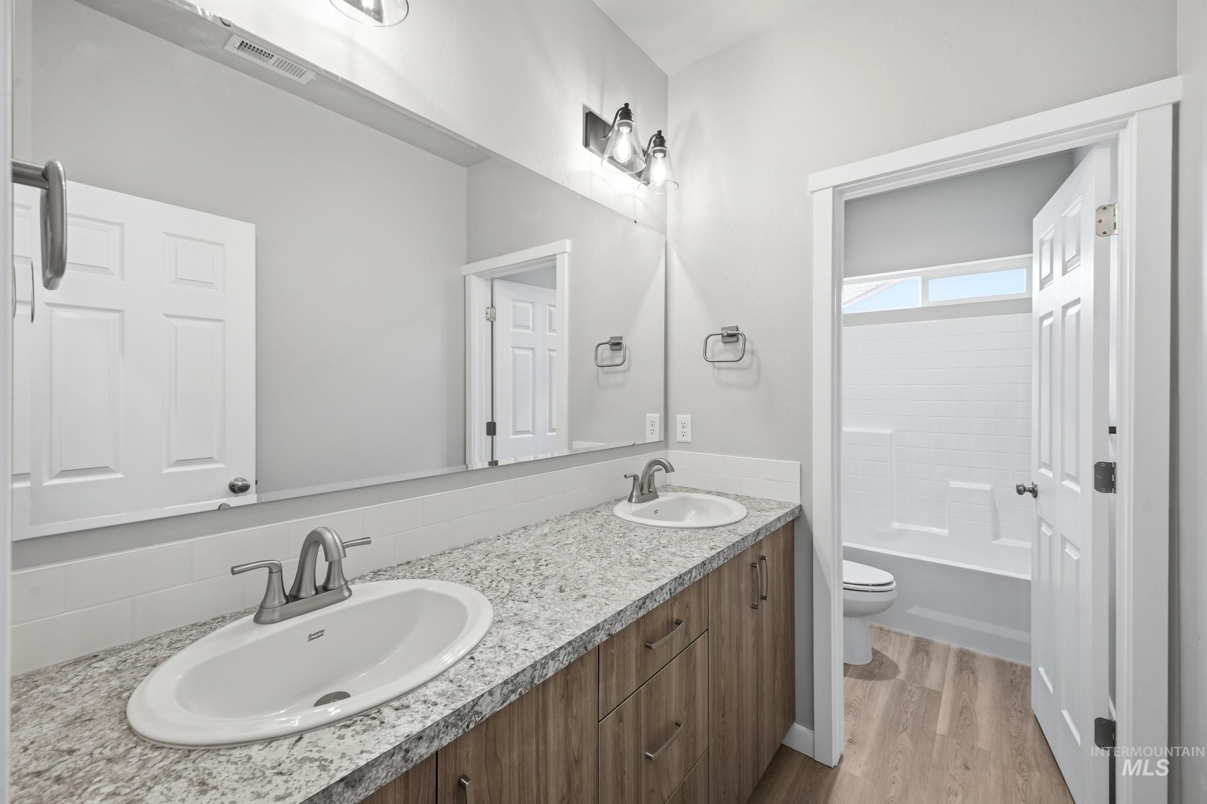 13672 Redway Court Caldwell, ID 83607 - Photo 26 of 34 Bathroom with double vanity, light wood finished floors, and bathing tub / shower combination