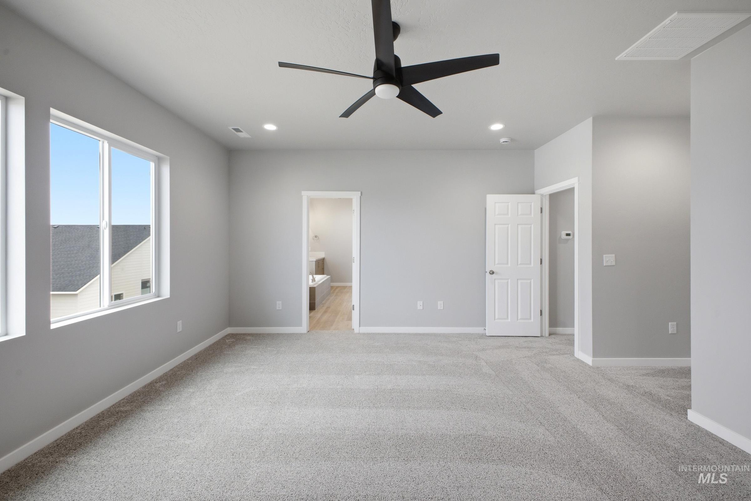 13672 Redway Court Caldwell, ID 83607 - Photo 29 of 34 Unfurnished bedroom with ensuite bathroom, light colored carpet, a ceiling fan, and recessed lighting