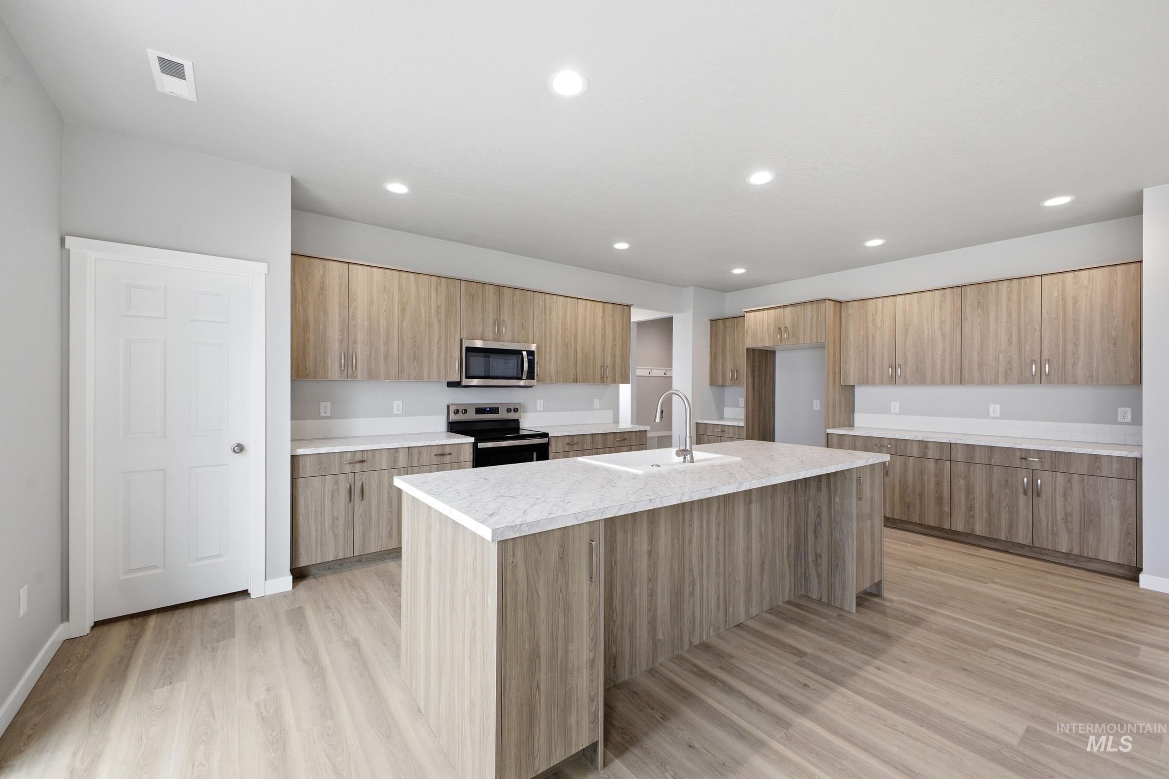13672 Redway Court Caldwell, ID 83607 - Photo 4 of 34 Kitchen with an island with sink, stainless steel appliances, light wood-type flooring, recessed lighting, and modern cabinets