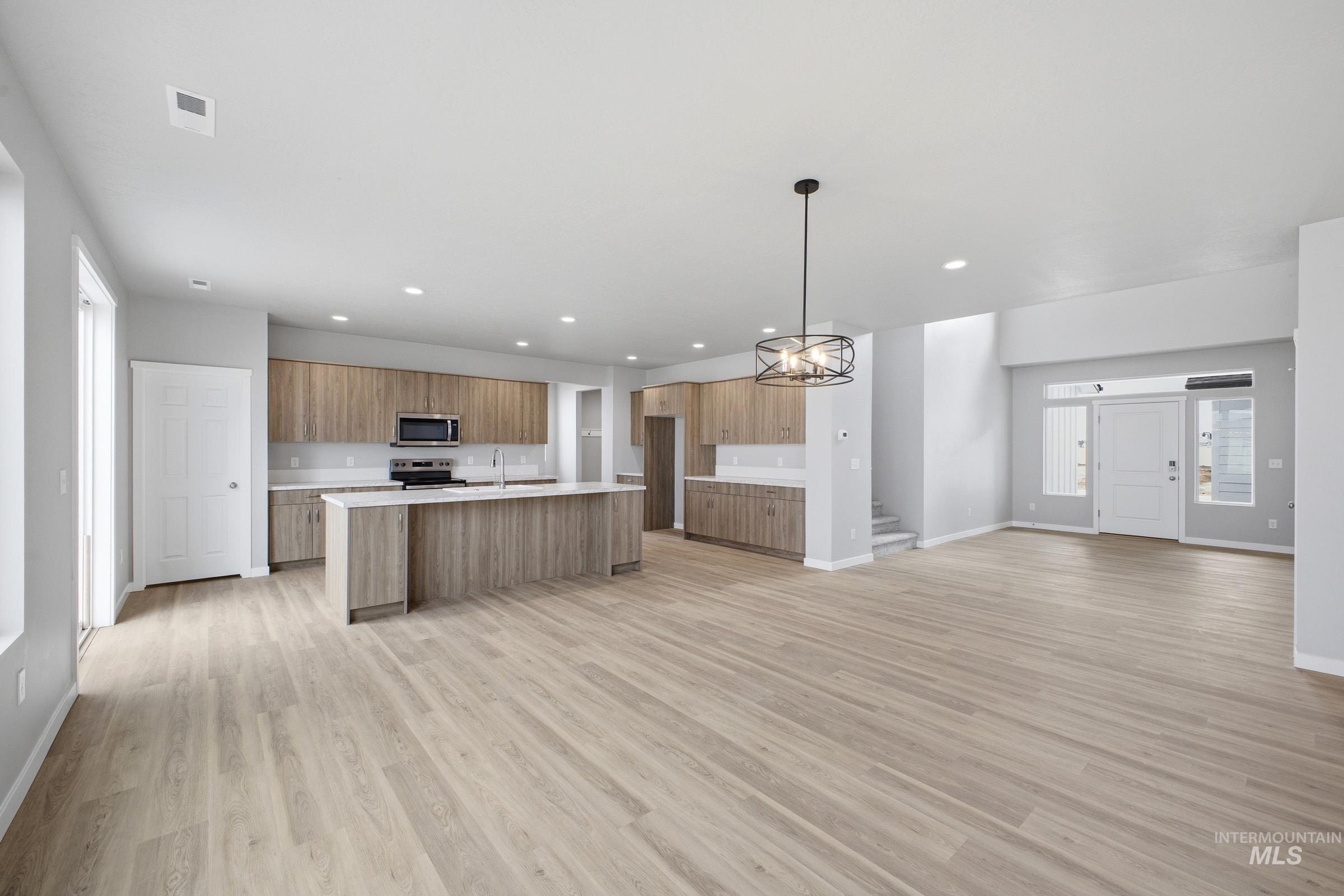 13672 Redway Court Caldwell, ID 83607 - Photo 34 of 34 Kitchen featuring open floor plan, an island with sink, light wood-style flooring, and modern cabinets