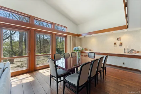 a bedroom with a bed a couch and a large window