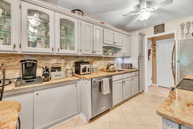 a kitchen with stainless steel appliances granite countertop a stove sink and cabinets