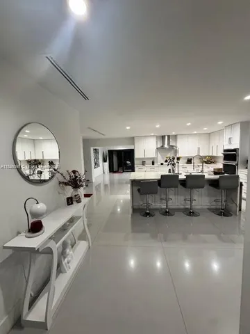 a living room with furniture and a mirror