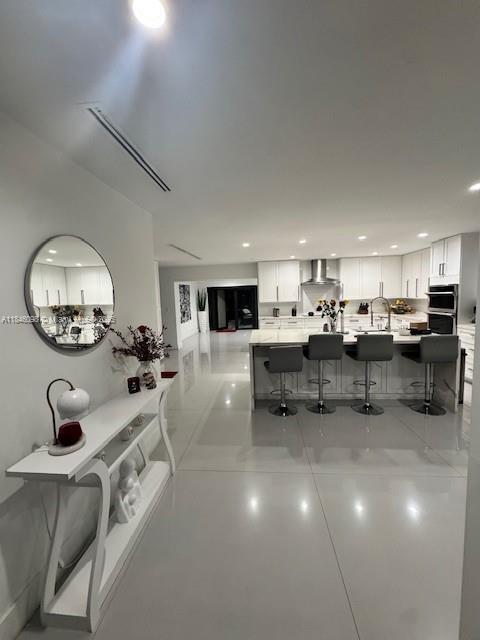 4229 West 7th Lane Hialeah, FL 33012 - Photo 1 of 6 a living room with furniture and a mirror