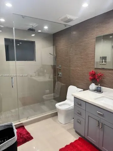 a bathroom with a sink toilet and shower
