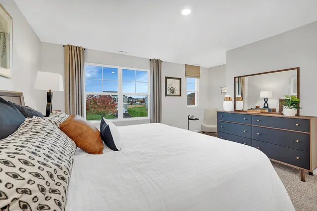 a bedroom with a bed and a dresser