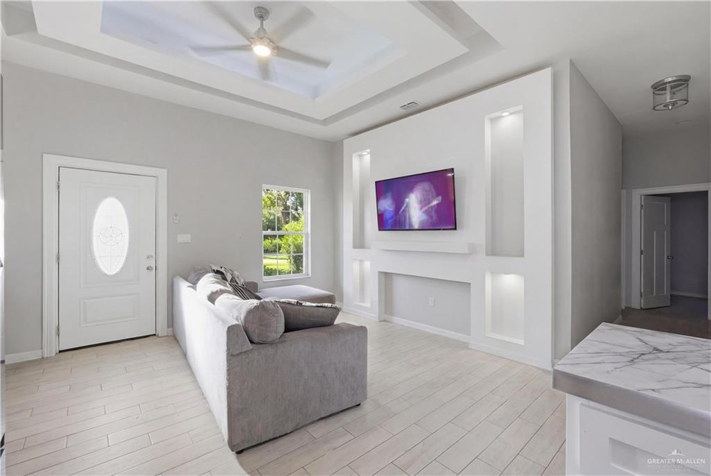 804 Hawk Street Alamo, TX 78516 - Photo 2 of 14 a living room with furniture and a fireplace