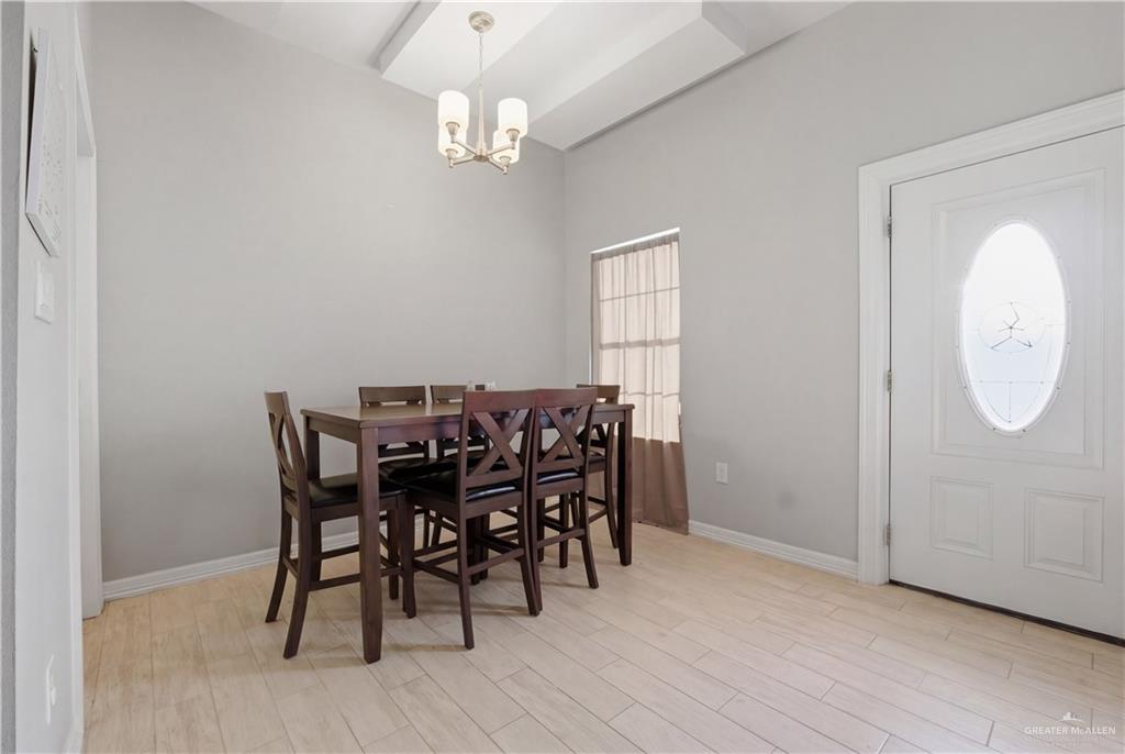804 Hawk Street Alamo, TX 78516 - Photo 4 of 14 a view of a dining room with furniture and wooden floor