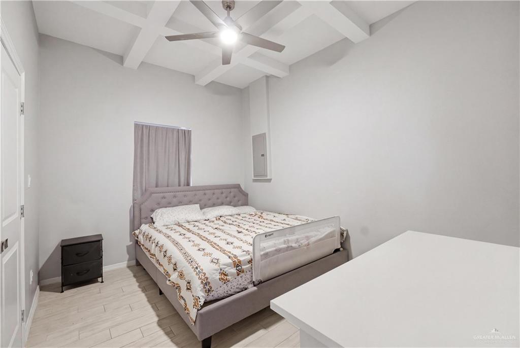 804 Hawk Street Alamo, TX 78516 - Photo 7 of 14 a bedroom with a bed and a chandelier