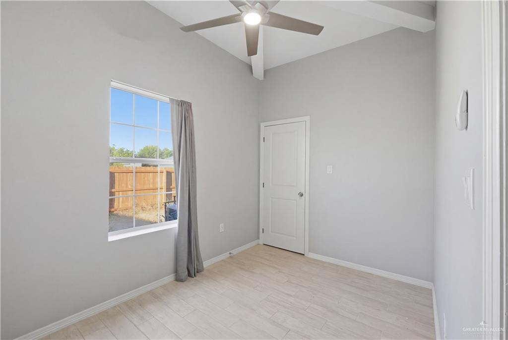 804 Hawk Street Alamo, TX 78516 - Photo 8 of 14 an empty room with fan and windows