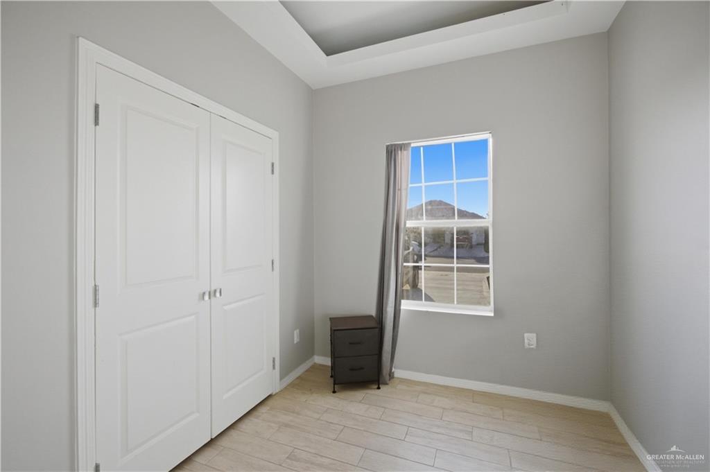 804 Hawk Street Alamo, TX 78516 - Photo 10 of 14 a view of an empty room with wooden floor and a window