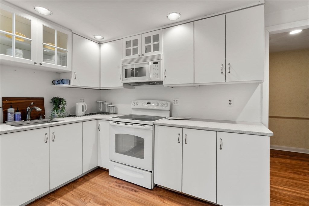 75 Grove Street, Unit 227 Wellesley, MA 02482 - Photo 14 of 29 a kitchen with cabinets appliances a sink and a counter top space