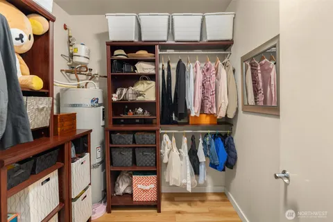 a view of walk in closet with clothes and shoes