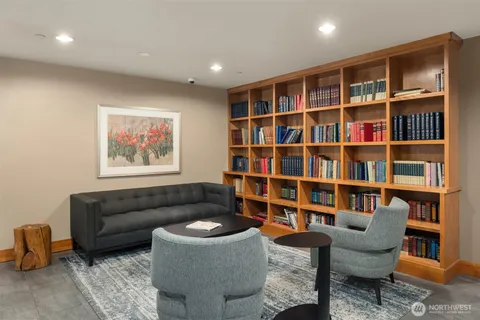 a living room with furniture and a book shelf
