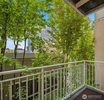 a view of a balcony with tree