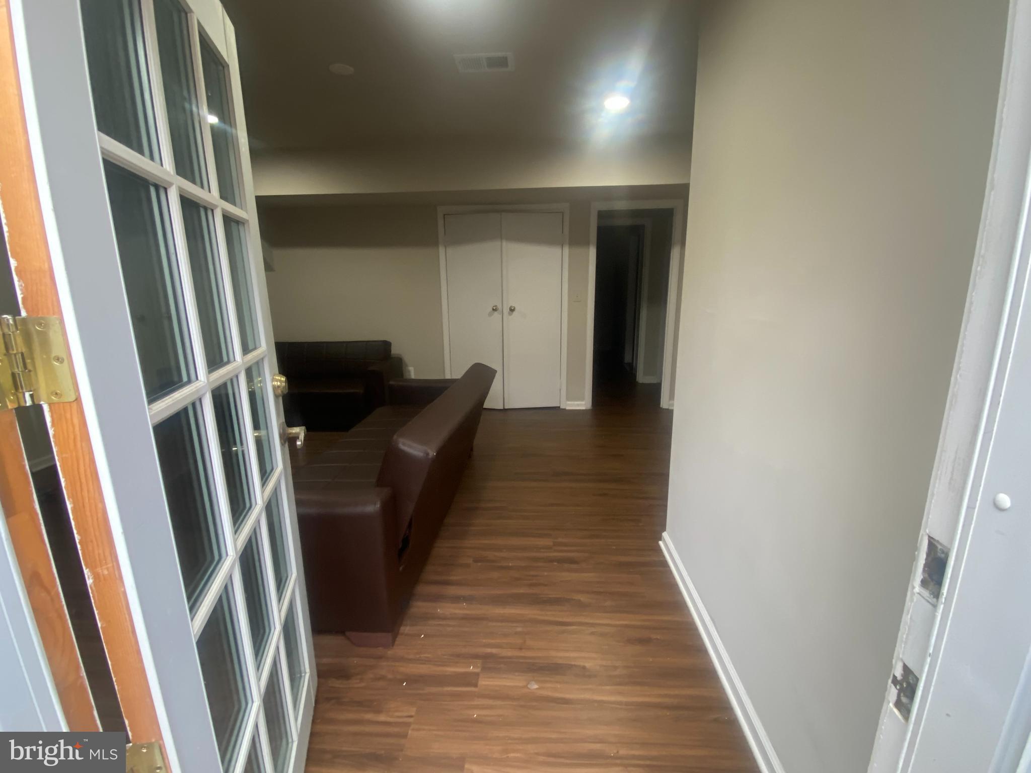 7307 Brooklyn Bridge Road Laurel, MD 20707 - Photo 6 of 9 a hallway with wooden floor and stairs
