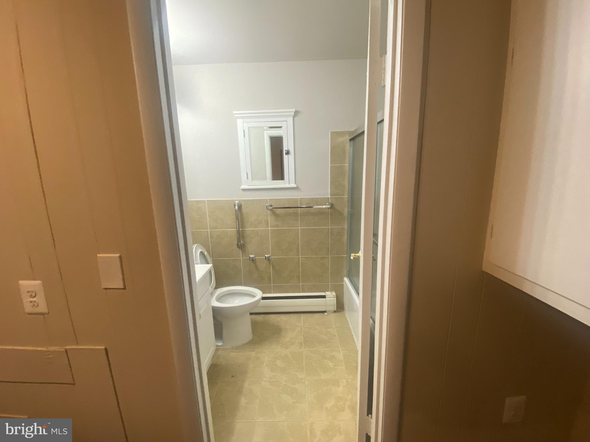 7307 Brooklyn Bridge Road Laurel, MD 20707 - Photo 9 of 9 a bathroom with a granite countertop toilet and a sink