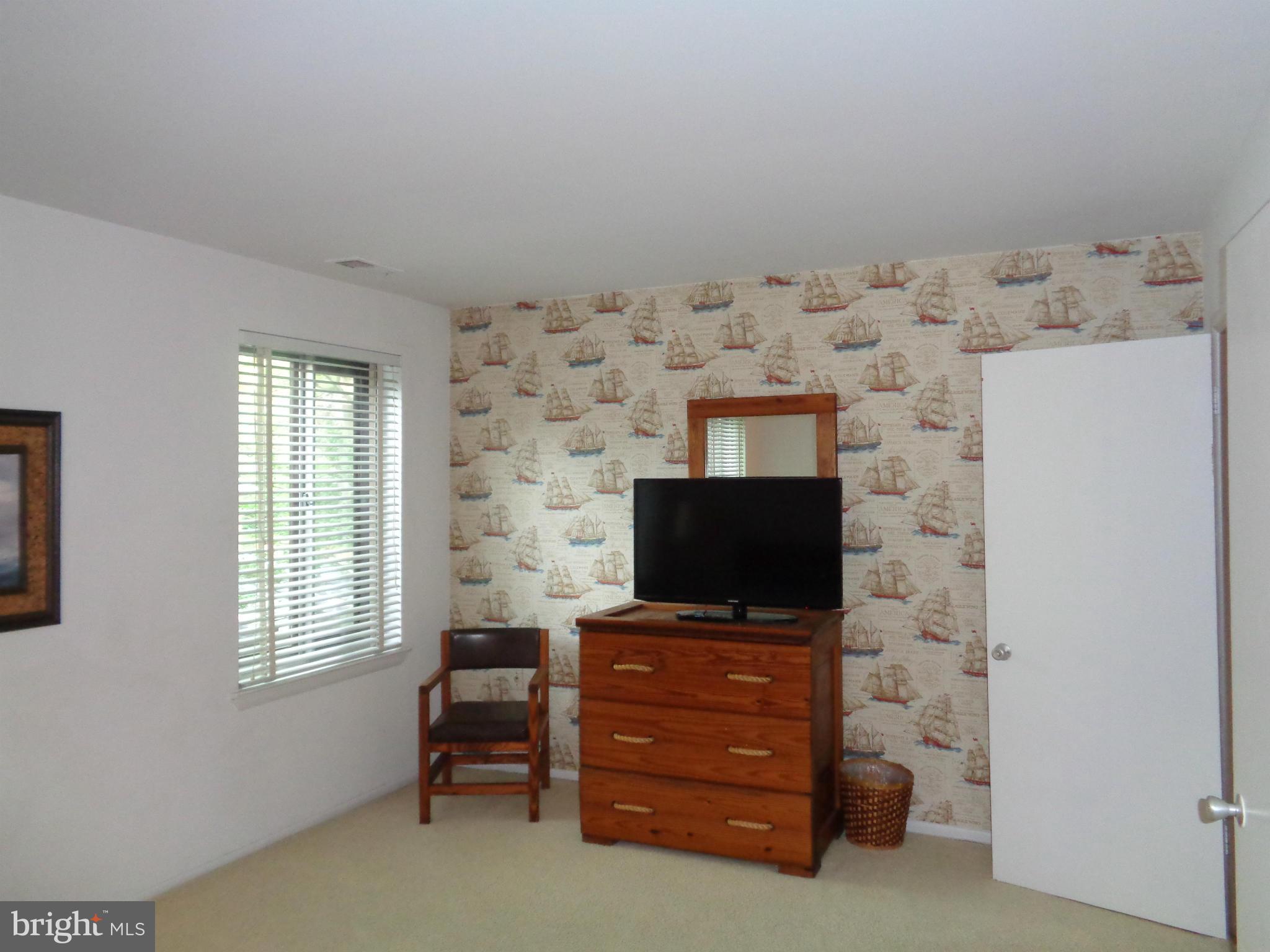 114 Cross Keys Road, Unit R114D Baltimore, MD 21210 - Photo 12 of 22 a living room with furniture and a flat screen tv