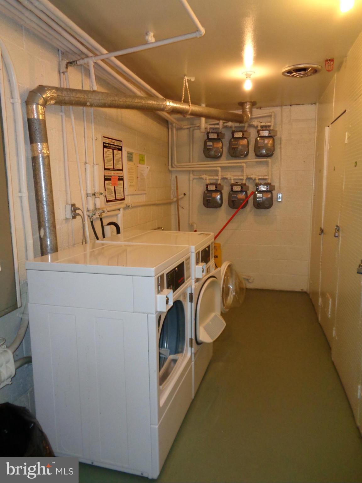114 Cross Keys Road, Unit R114D Baltimore, MD 21210 - Photo 19 of 22 a utility room with dryer and washer