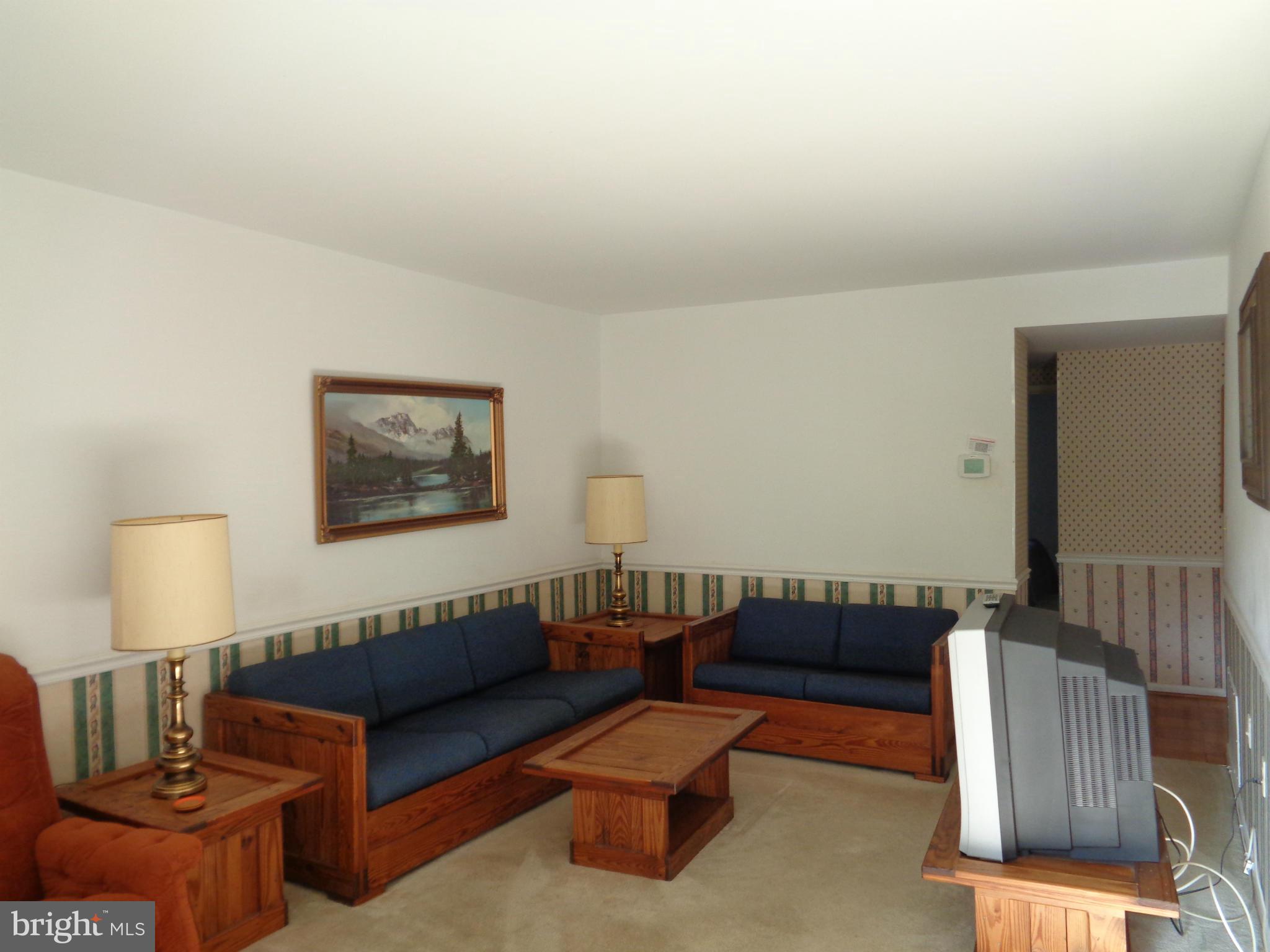 114 Cross Keys Road, Unit R114D Baltimore, MD 21210 - Photo 3 of 22 a living room with furniture and a lamp