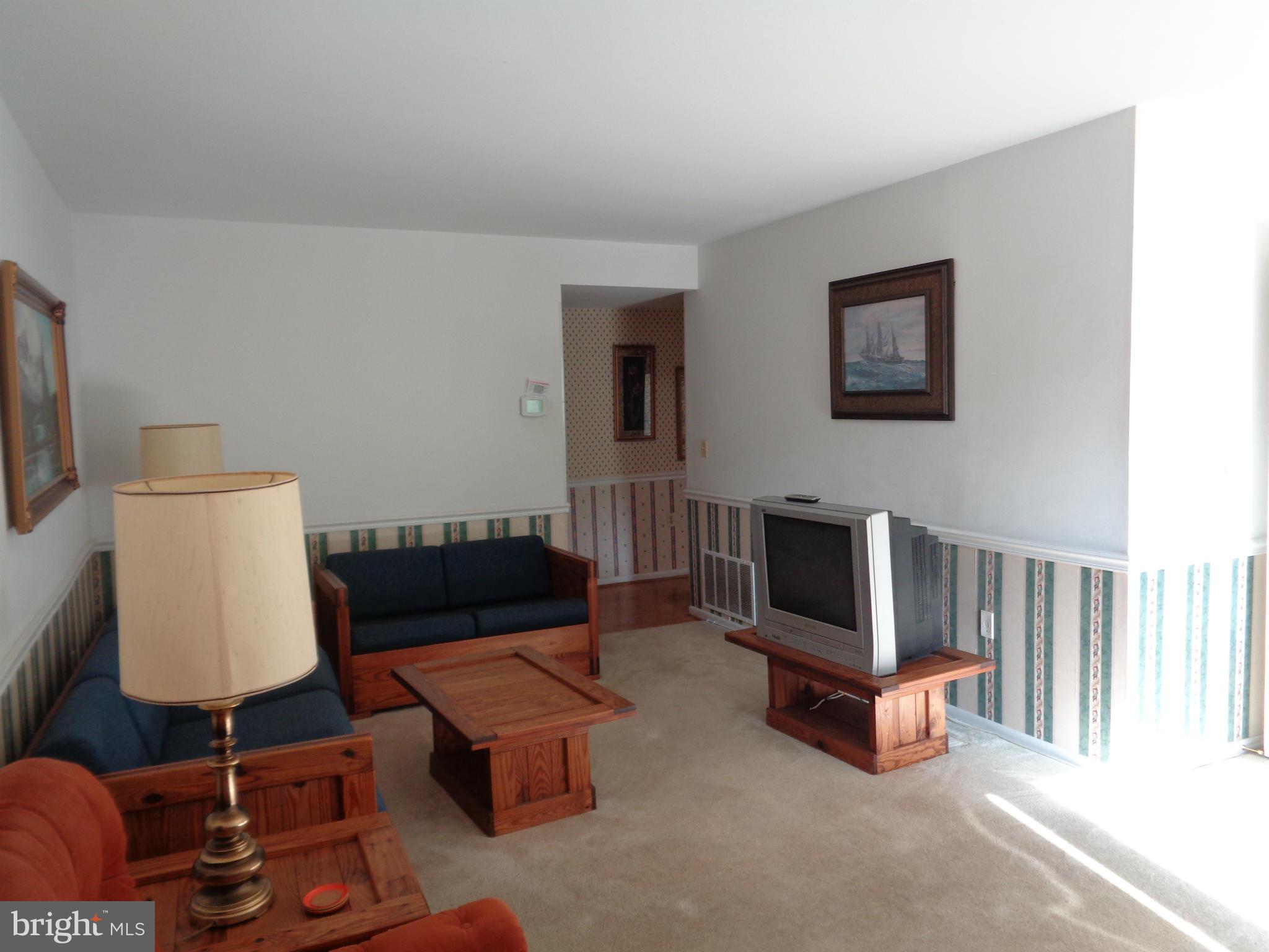 114 Cross Keys Road, Unit R114D Baltimore, MD 21210 - Photo 4 of 22 a living room with furniture and a fireplace